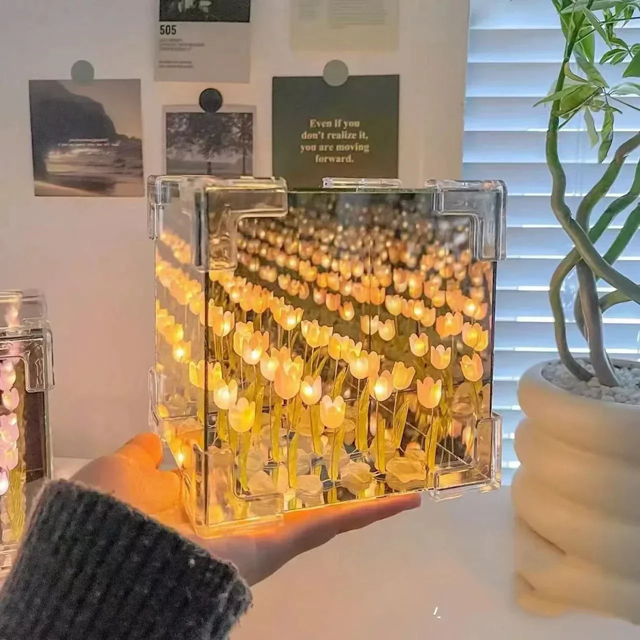 A person assembling the creative and fun 3D Tulip DIY Flower Cube Night Lamp.