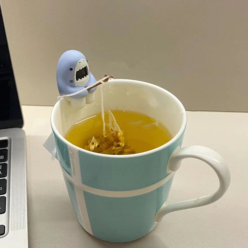Silicone shark gadget holding a tea bag string securely