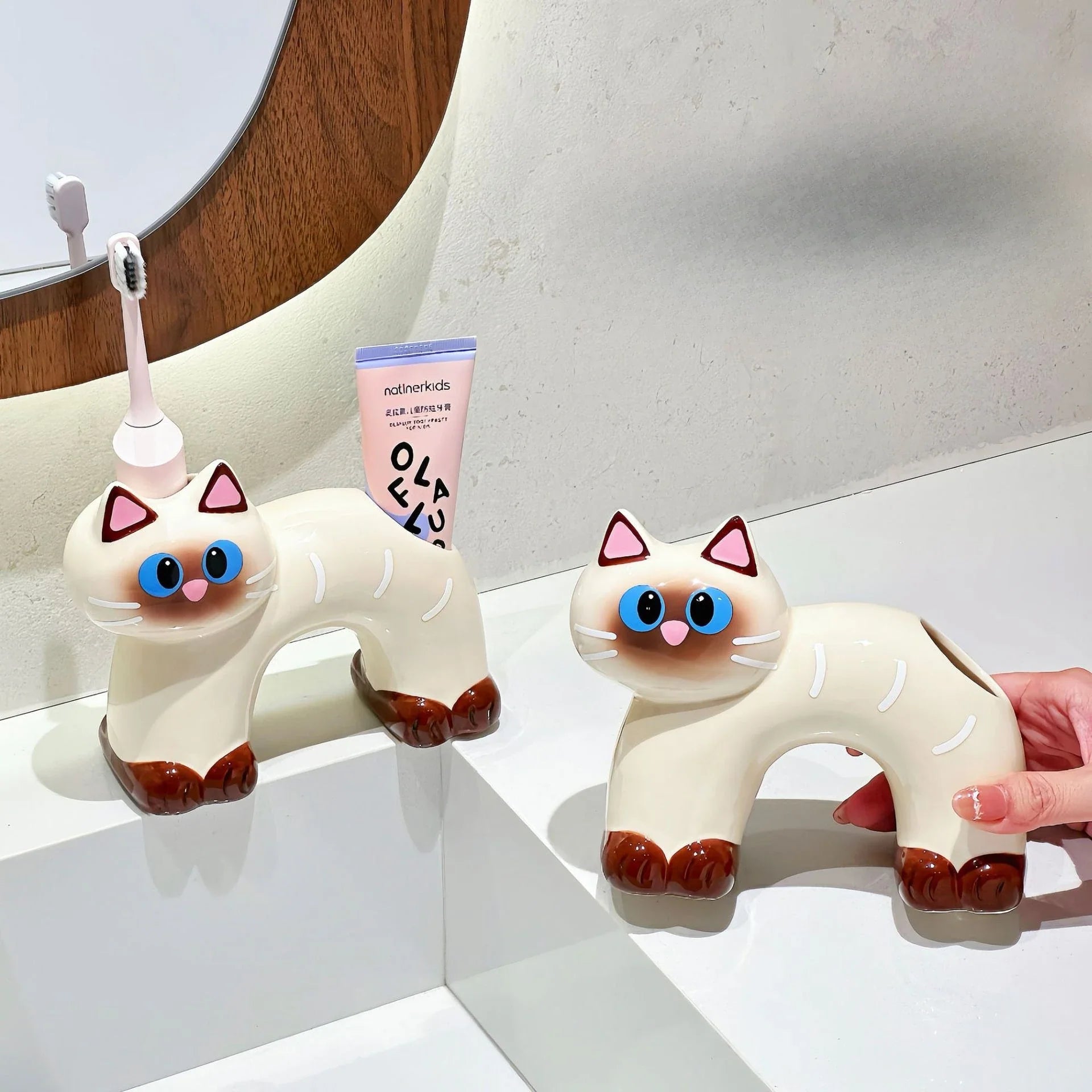 Close-up of the ceramic cat holder's playful design