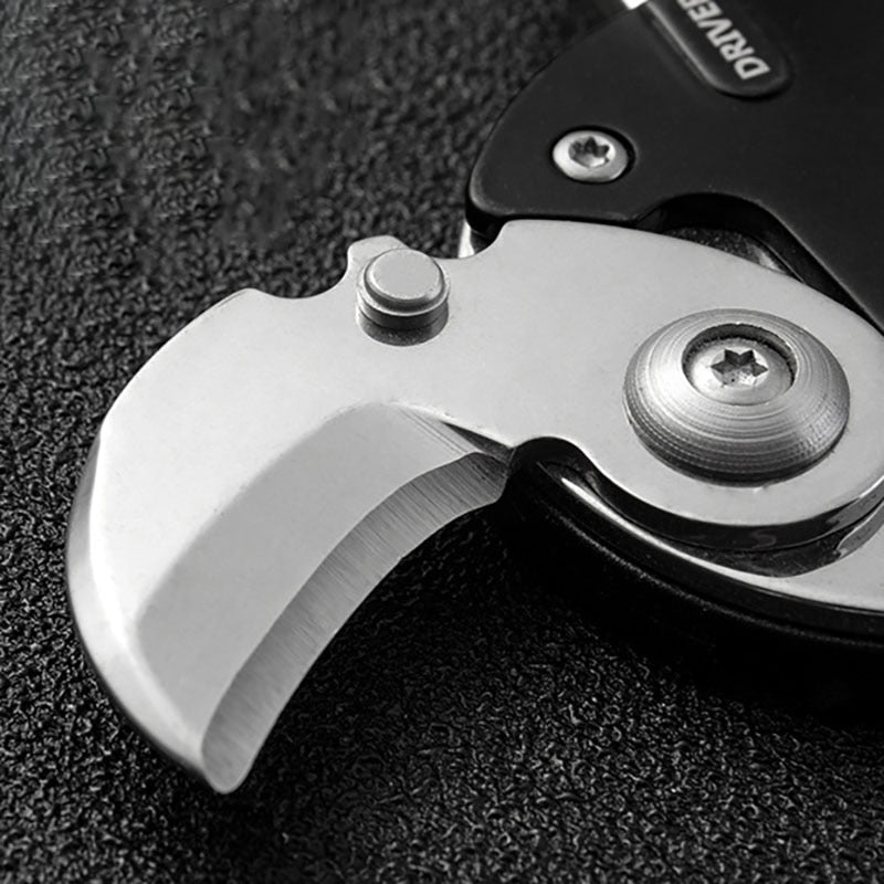 Holding the survival keychain tool to show its compact and convenient scale