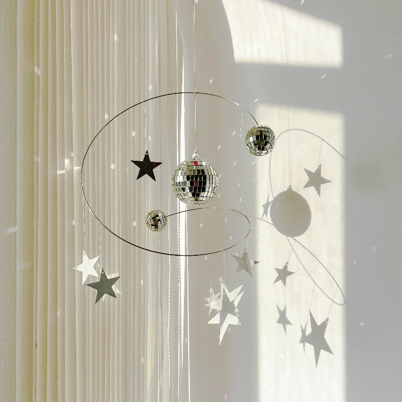 The celestial wind chime hanging in a sunlit room creating a dreamy atmosphere
