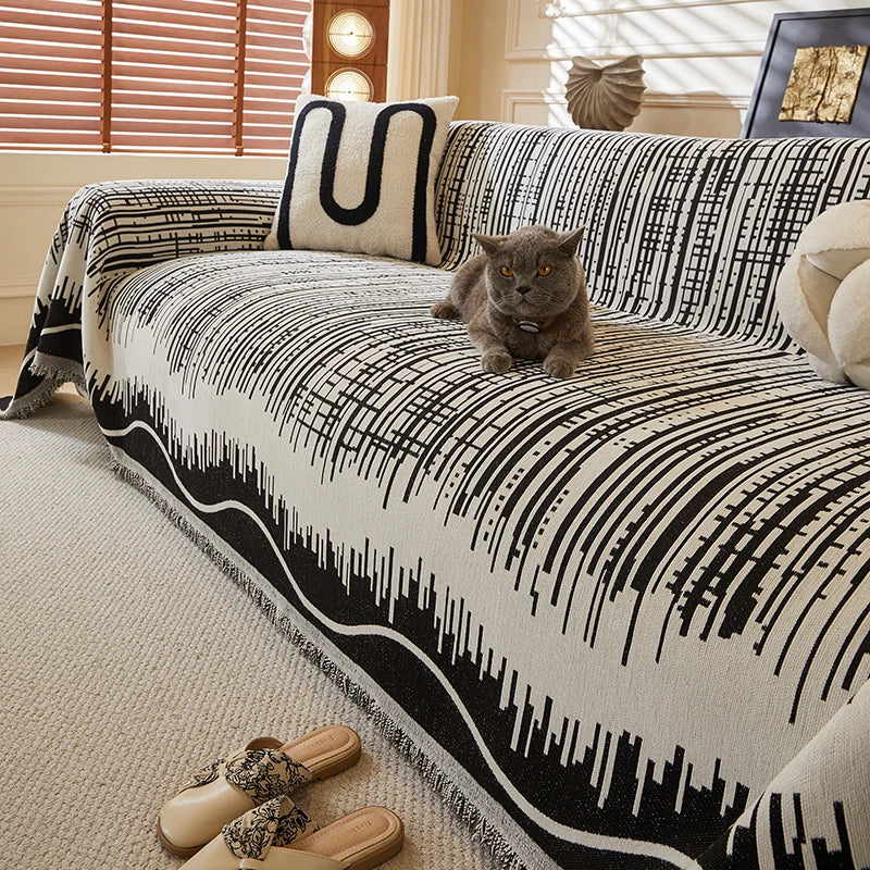 Modern geometric throw blanket draped over a neutral-colored sofa