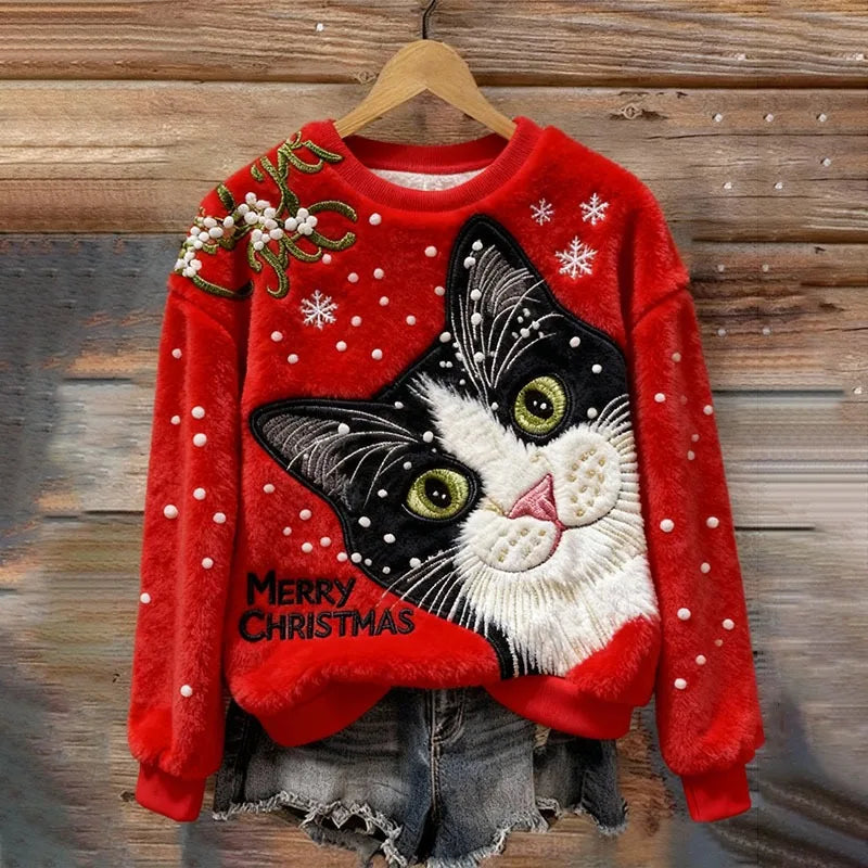 Close-up of the Christmas Village Plush Sweater's detailed festive design