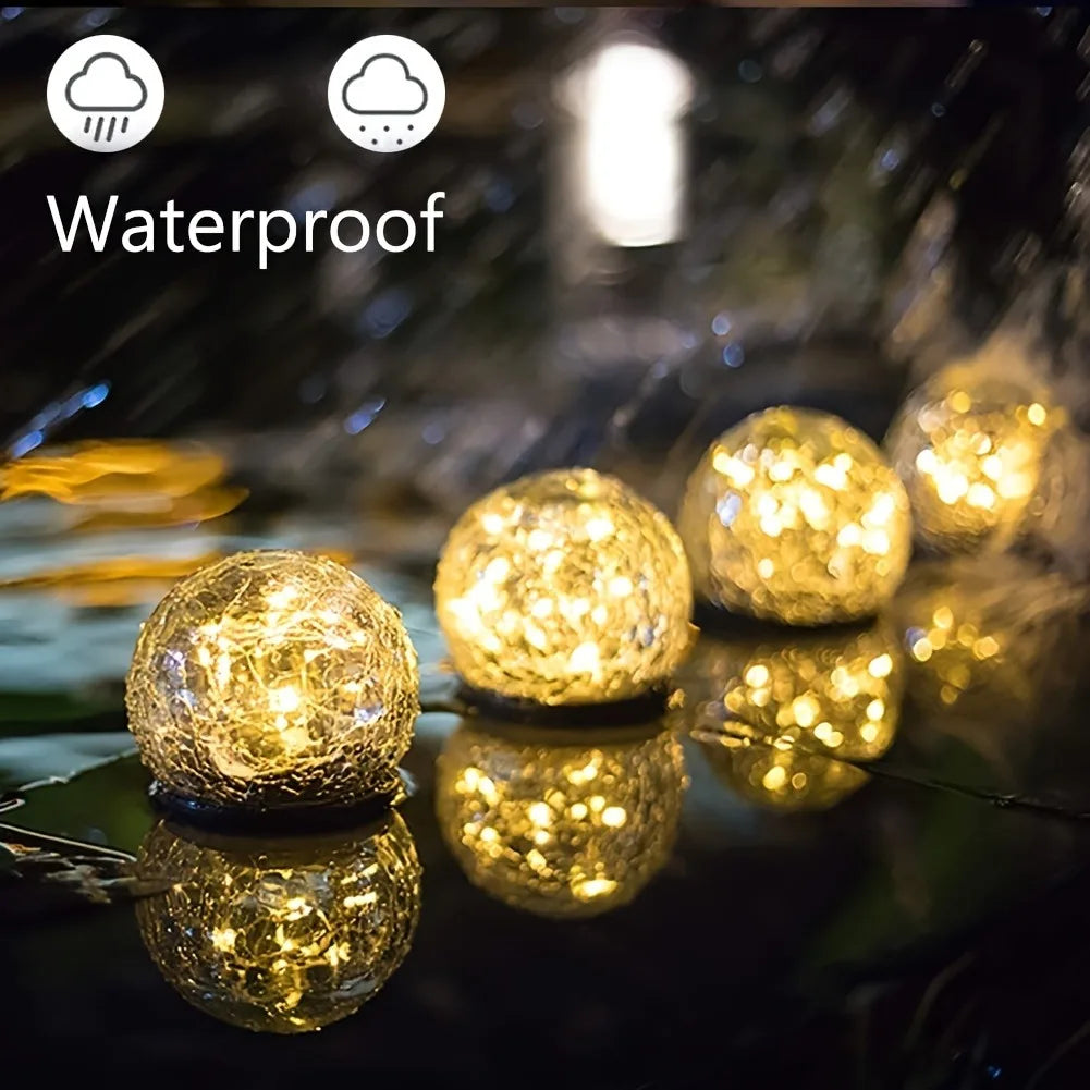Multiple solar powered glass ball lights creating an enchanting garden scene