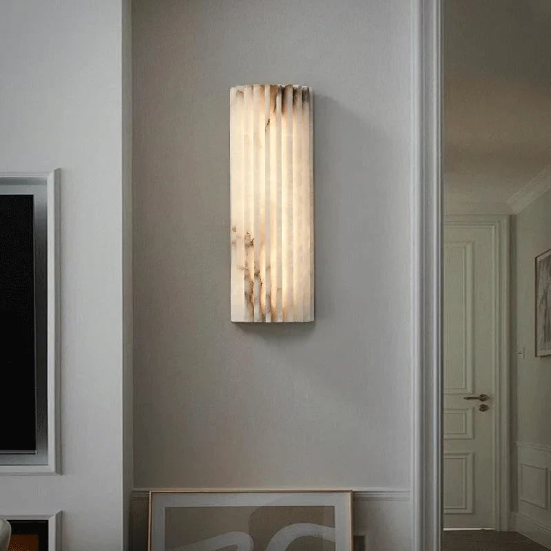 Vertical wall-mounted light in a serene bedroom setting