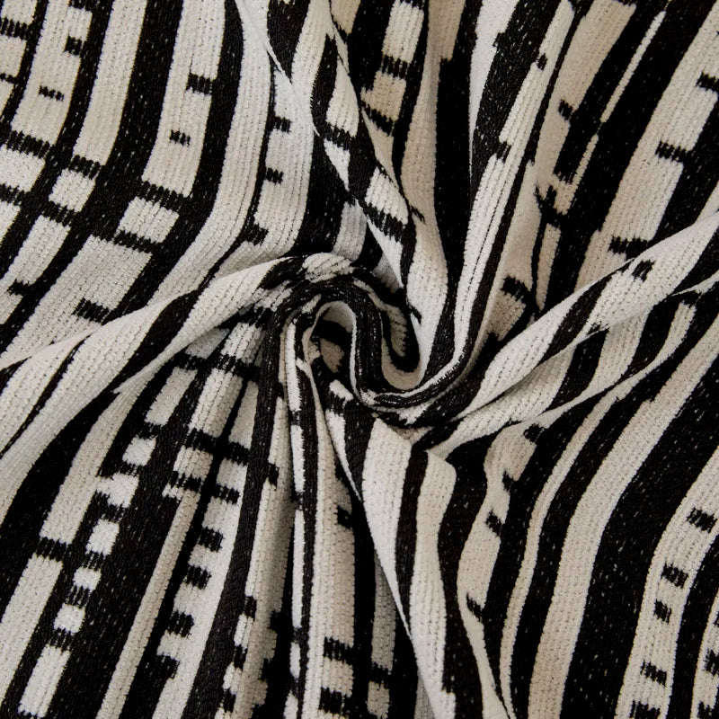 Person relaxing under the cozy Geometric Lines Sofa Throw Cover Blanket