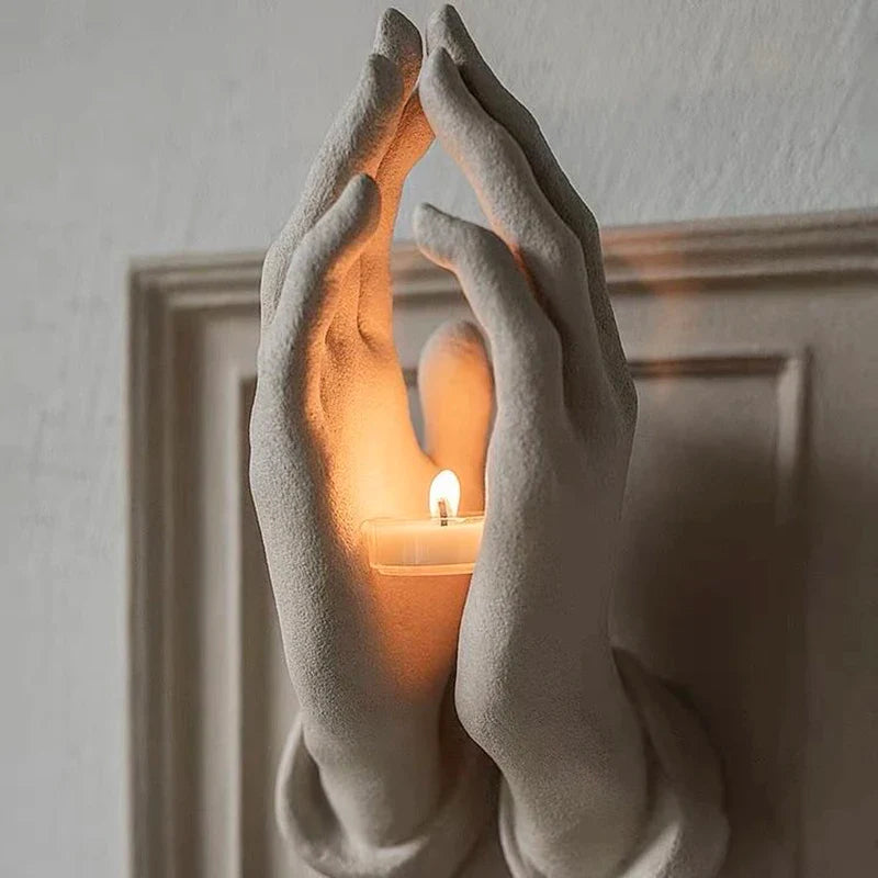 Close-up detail of the resin praying hands candle holder