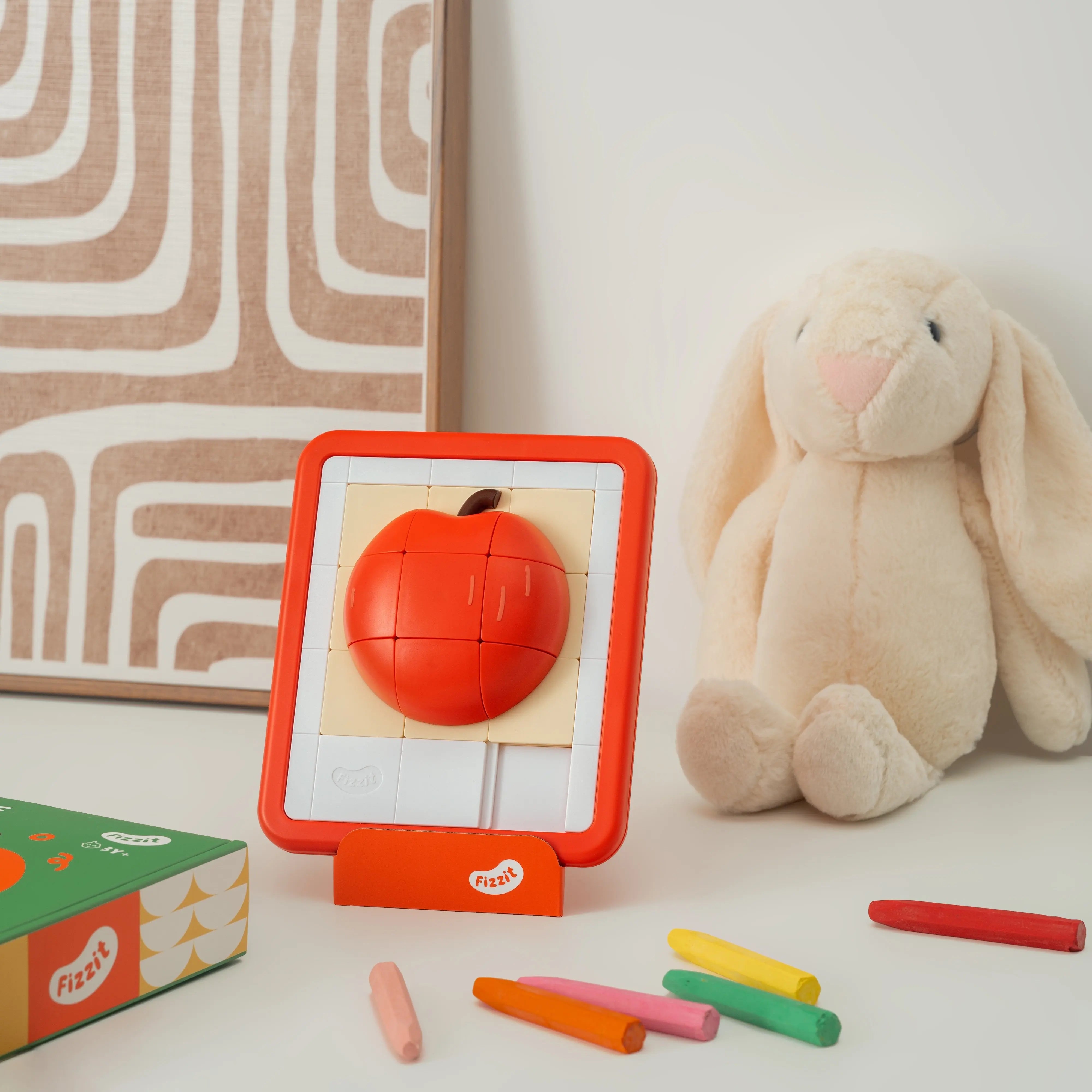 Lifestyle shot of the Apple puzzle toy on a desk