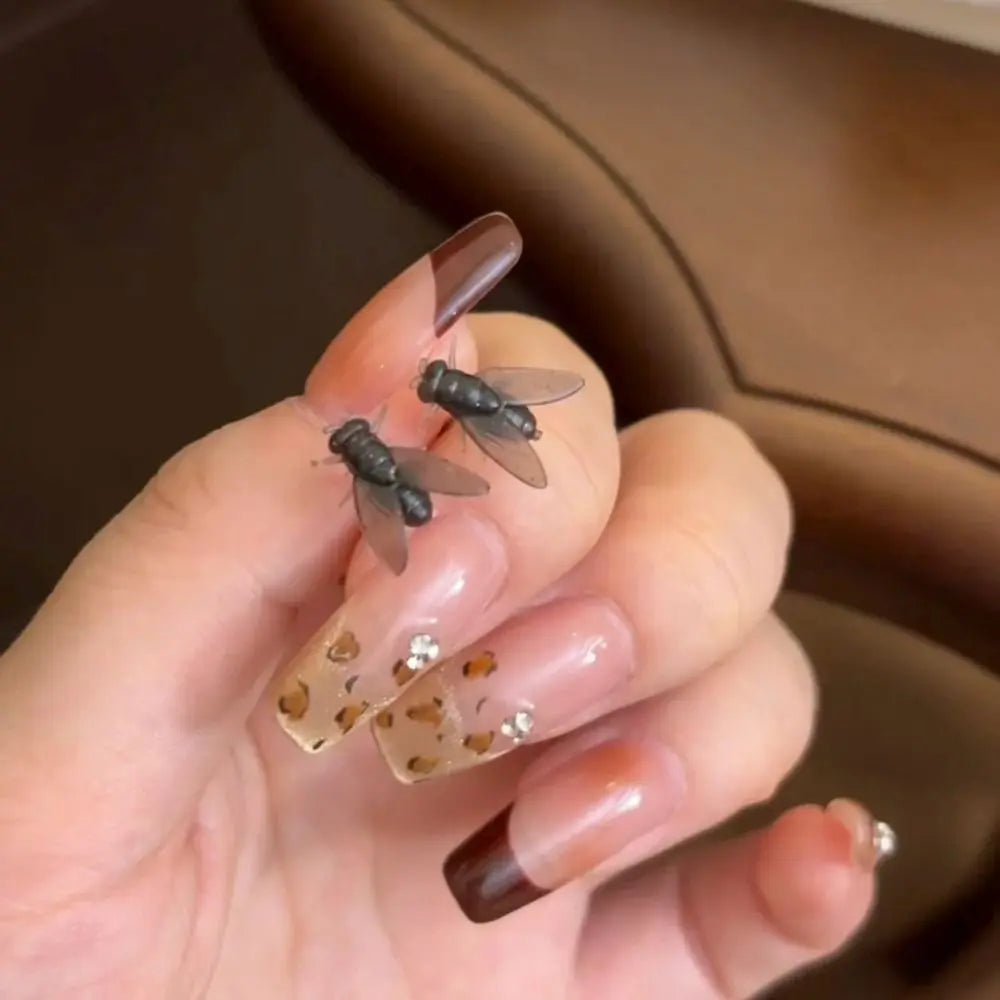 Unique Realistic Fly Abstract Earrings gift idea resting on a surface