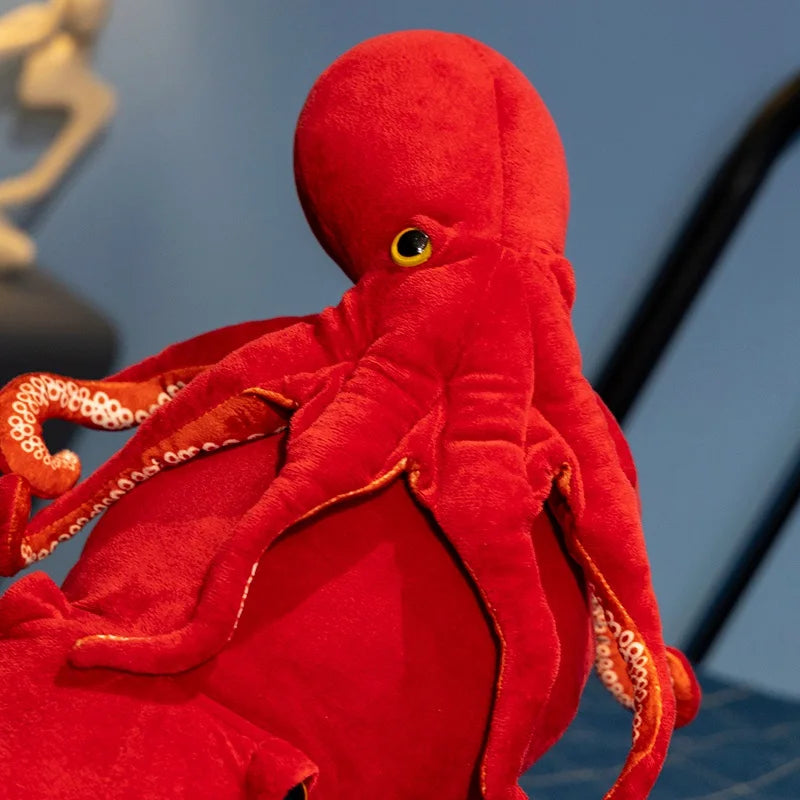 Close-up of the soft plush texture of the red octopus toy