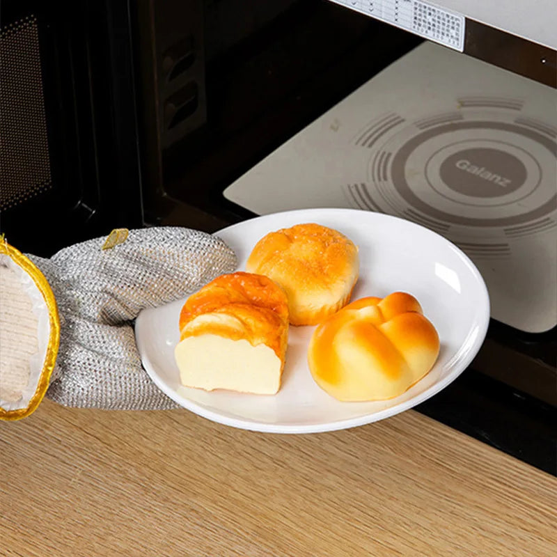 Using the heat-resistant gloves to clean a hot pan