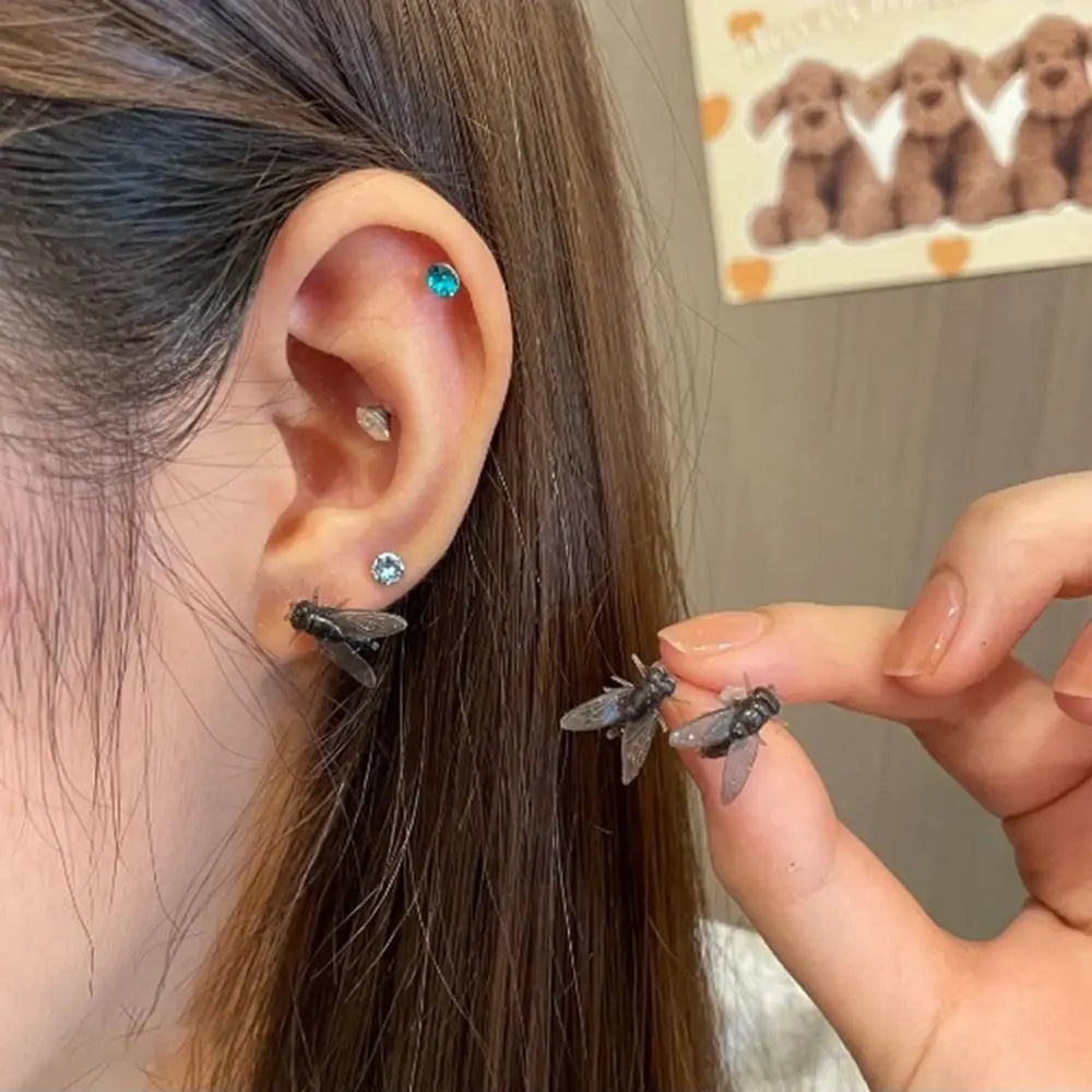 Another angle of the artistic fly earrings showcasing their design