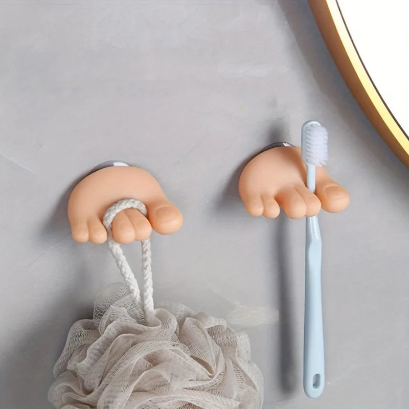 A pair of Toe-Grip Wall Toothbrush Holders showcasing their fun design