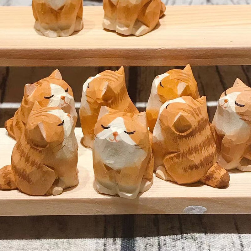 Handmade wooden cat and dog figurines on a shelf