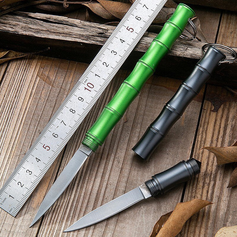 A person holding the compact Bamboo Camping Knife in their palm