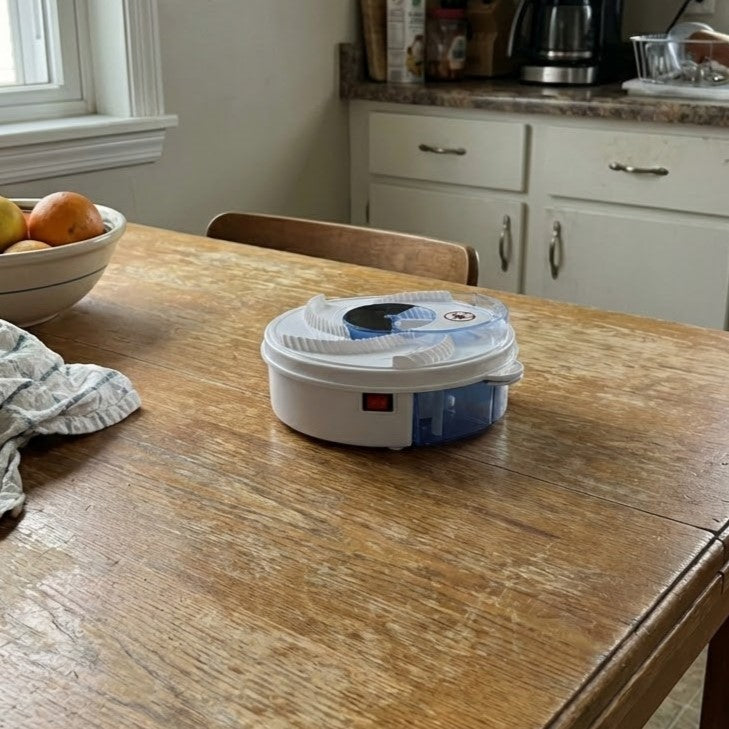 The Automatic Electric Flycatcher gadget shown on a wooden table